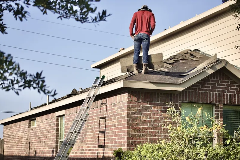 Professional roofer working on a residential roof in Carriage Stop